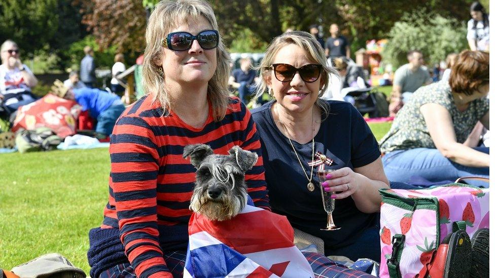 Women with dog draped in union flag