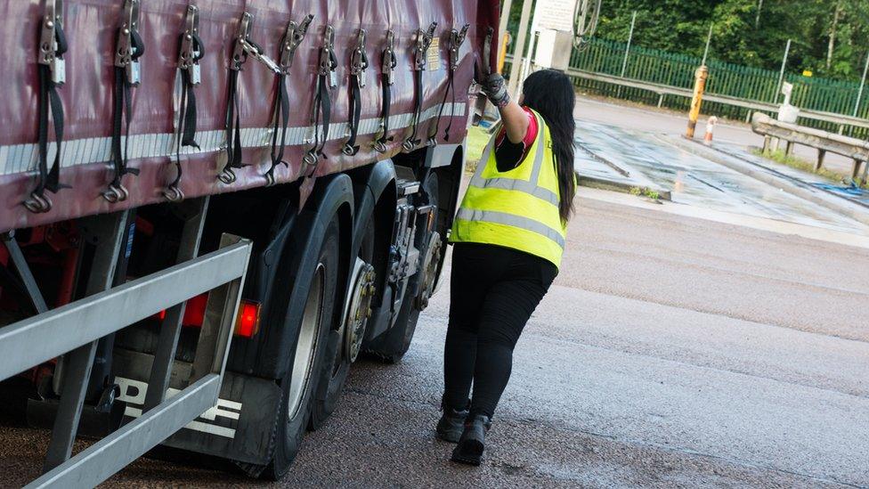 Leonie John pulling a trailer curtain closed