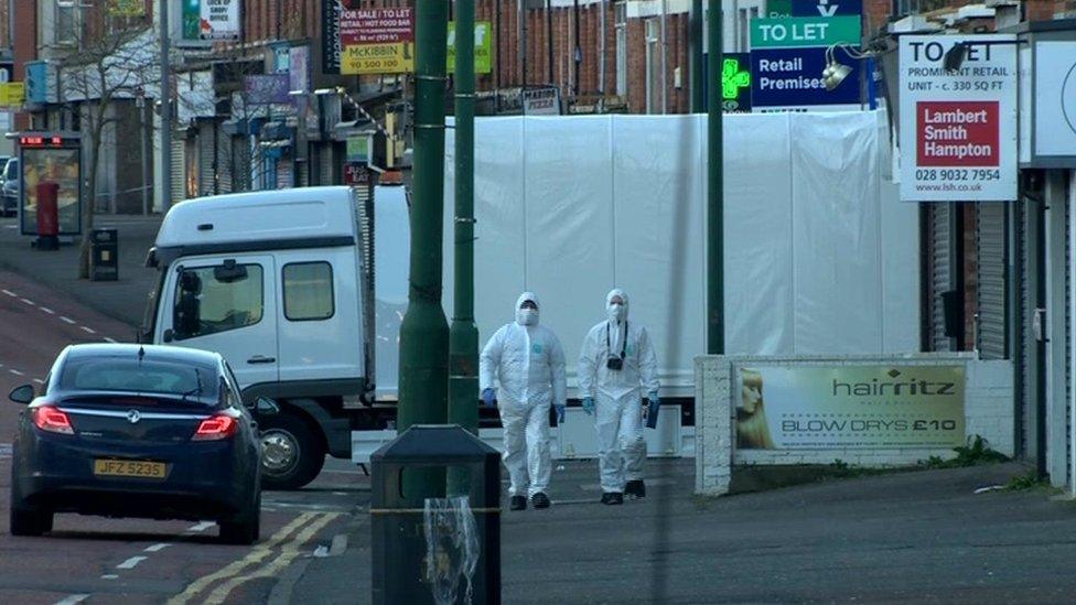 A lorry removes the van from the scene of the bombing