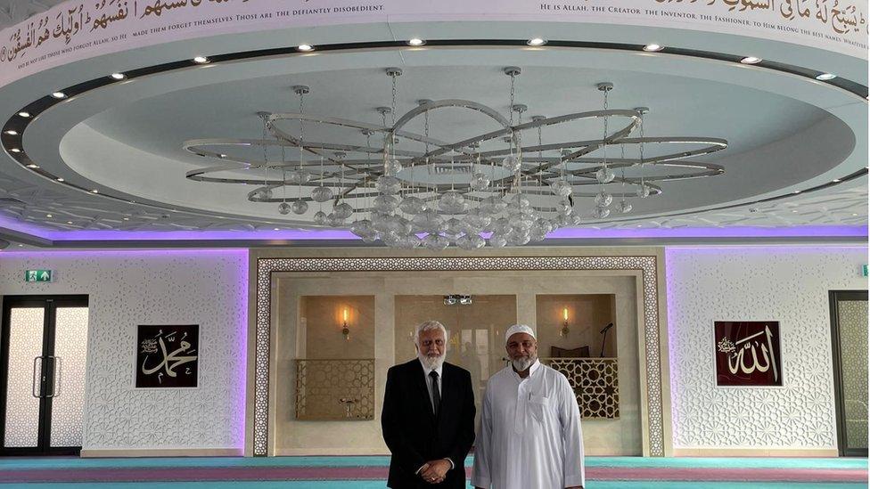 The mosque's interior is illuminated