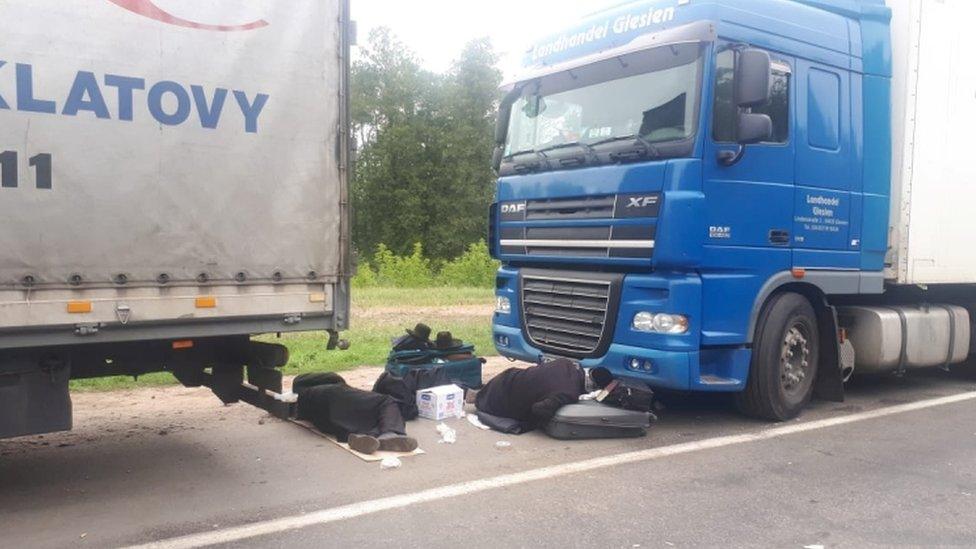 Jewish pilgrims rest between trucks near the Novi Yarylovychi crossing point