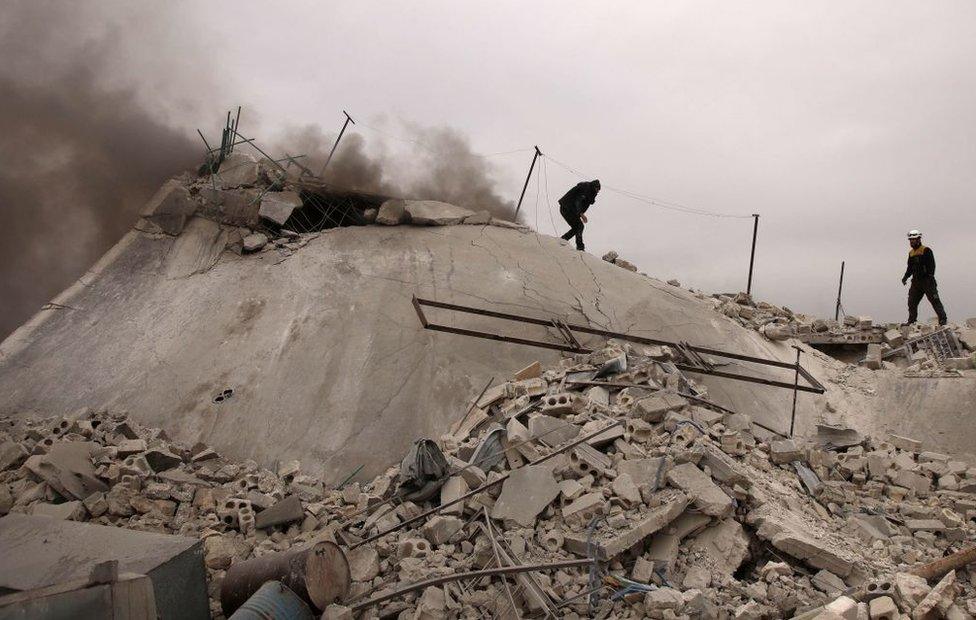 White Helmets approach a collapsed house in countryside west of Aleppo in February 2020