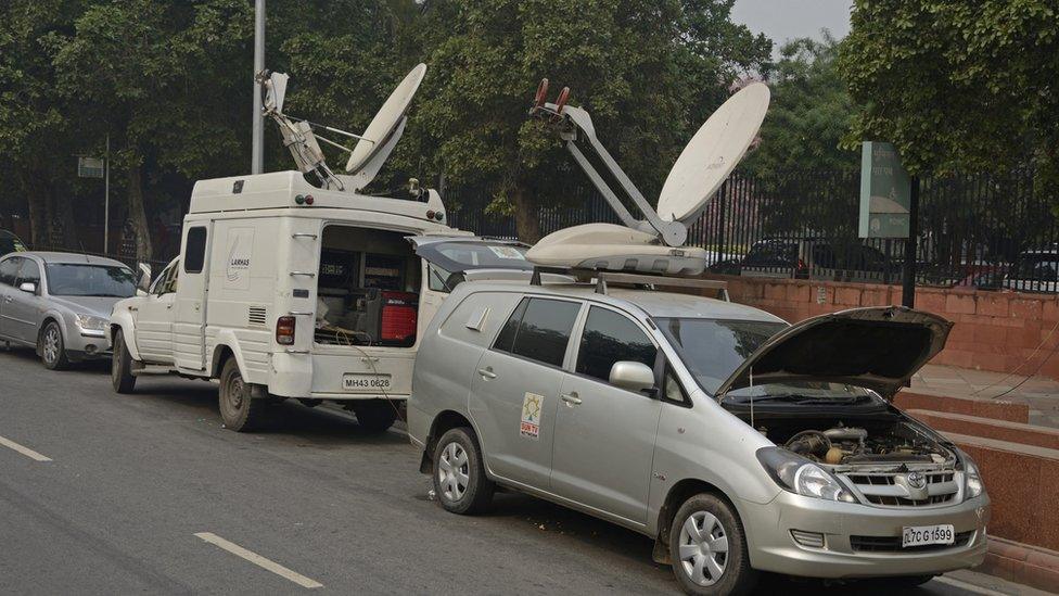 TV satellite vans parked in street in Delhi