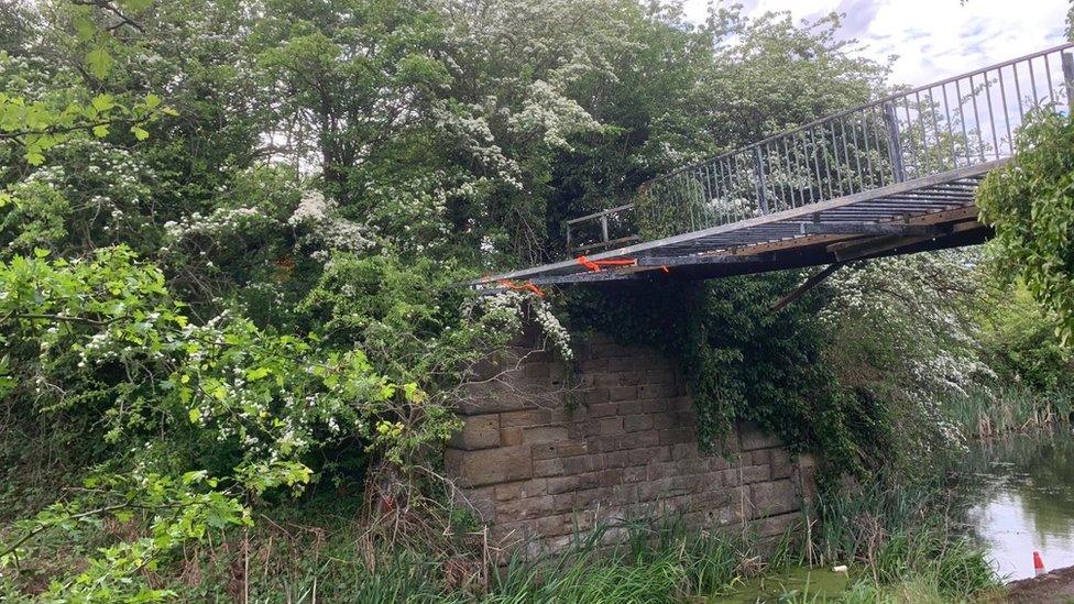 Damaged footbridge over canal