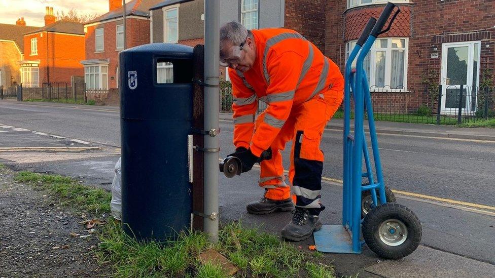 A bin is removed from Elan Close in Boston