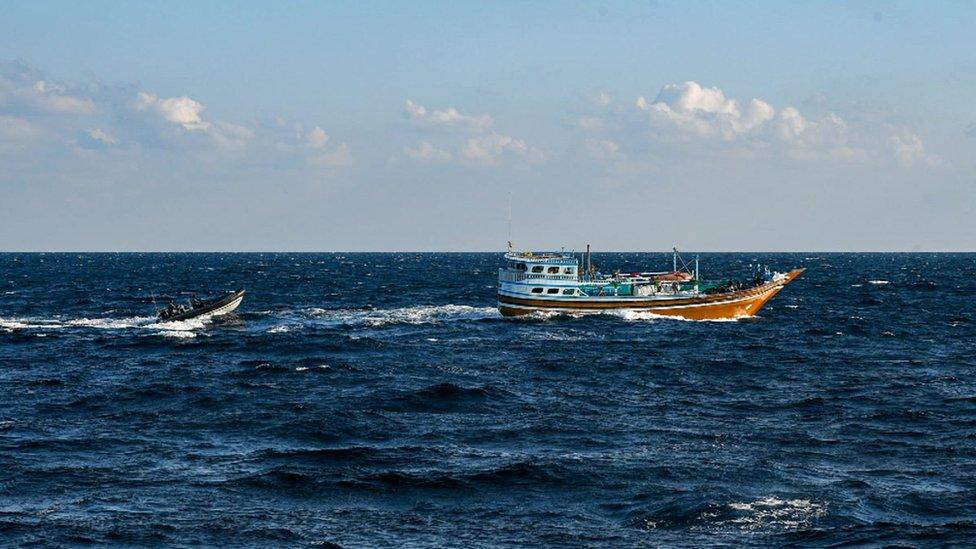 Royal Navy inflatable boat approaches suspect vessel