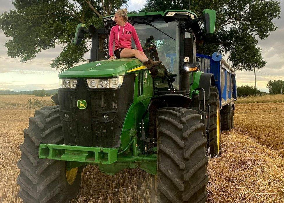 Caitlin Oxton sitting on her tractor