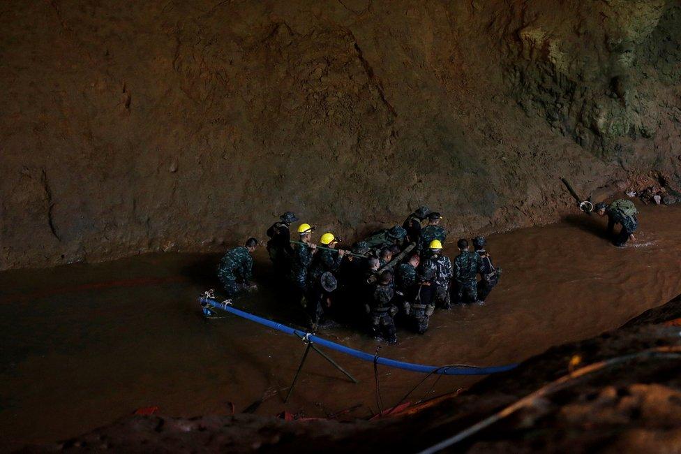 Soldiers and rescue workers work in Tham Luang cave complex