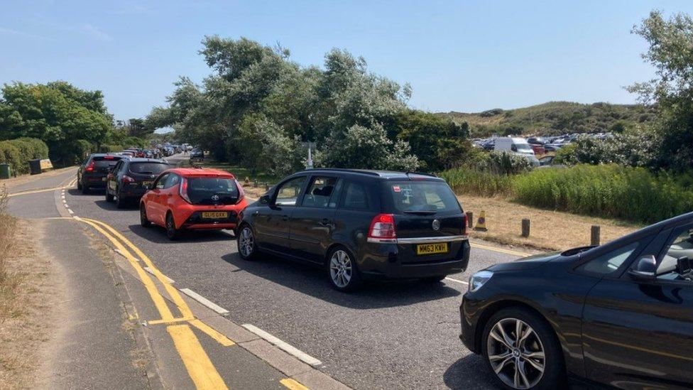 Cars on the approach to the beach