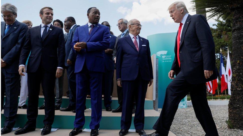 U.S. President Donald Trump arrives next to R-L: Tunisia"s President Beji Caid Essebsi, Nigerâ€™s President Mahamadou Issoufou, French President Emmanuel Macron and Italian Prime Minister Paolo Gentiloni for a family photo at the G7 Summit expanded session in Taormina, Sicily, Italy May 27, 2017