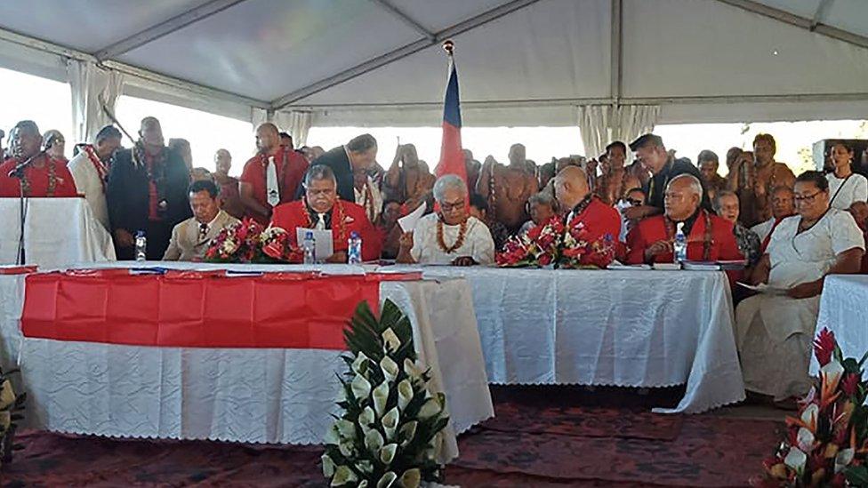 Fiame Naomi Mata'afa (seated C-in white) sits with members of parliament and the judiciary as she is sworn in as Samoa's first woman prime minister in Apia on May 24, 2021, at an extraordinary makeshift tent ceremony after the island nation's long-ruling government refused to cede power and locked the doors of parliament.