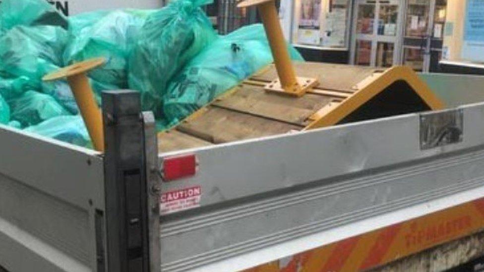 Parklet being taken away on the back of a truck