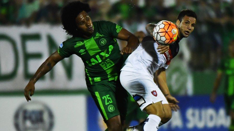 Facundo Costa of Argentina's San Lorenzo, vies for the ball with Kempes of Brazil's Chapecoense on 23 November