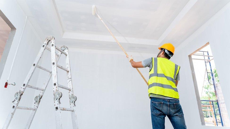 Man painting the ceiling