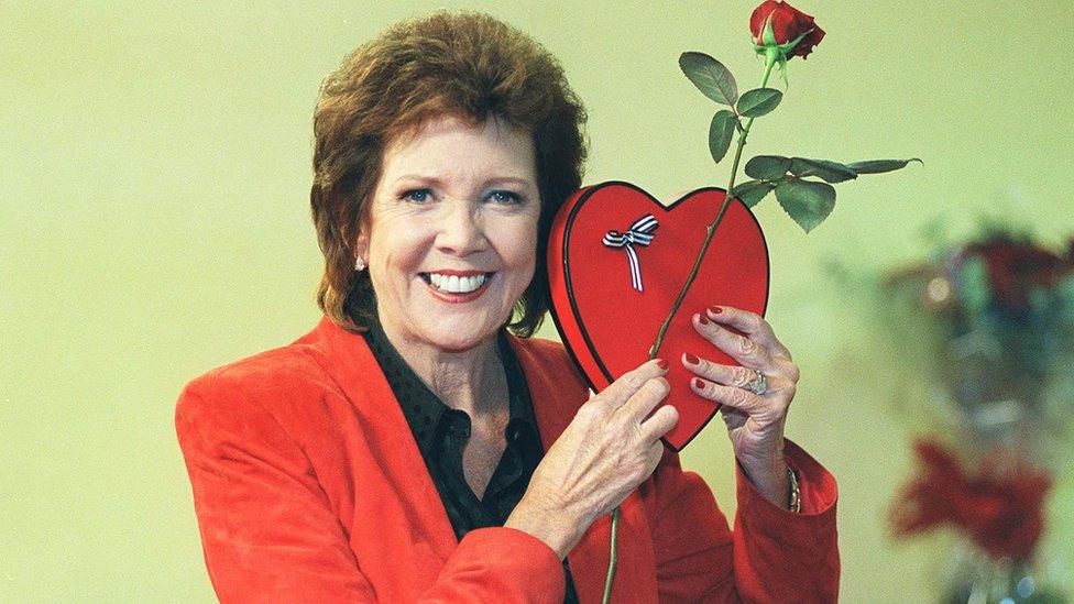 Cilla Black holding a heart-shaped box