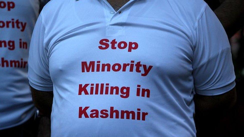 A Kashmiri Hindu, known as Pandit, wears a t-shirt reading 'Stop Minority Killing in Kashmir' during a protest against the recent targeted killings of civilians by militants in Indian-administered Kashmir, in New Delhi