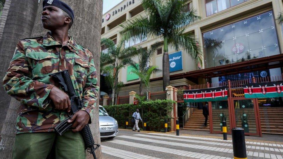 Kenyan police officer stands guard at the entrance of the Westgate Mall in Nairobi, Kenya, 21 September 2023