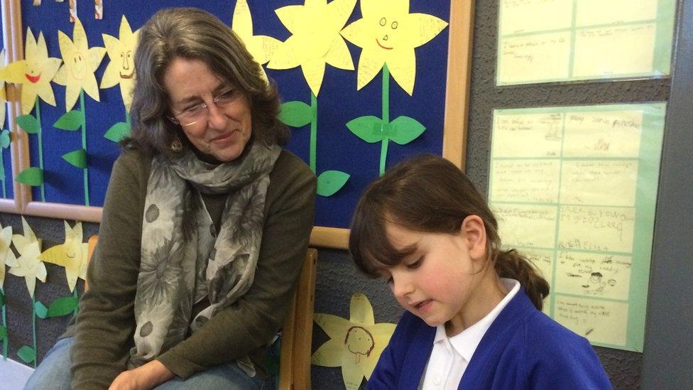 Volunteer reading to a child