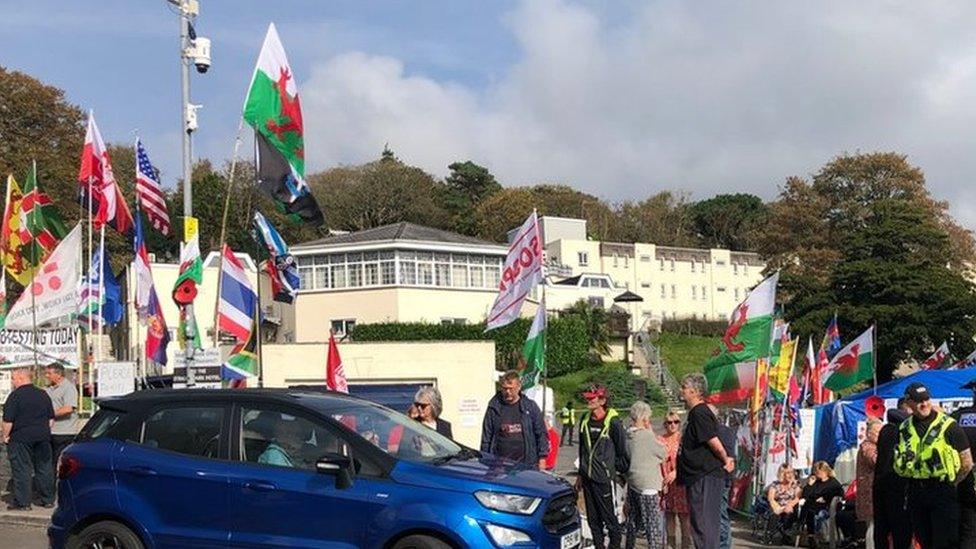 Outside Stradey Park hotel on Tuesday where crowds have gathered, there are also a couple of police officers standing there