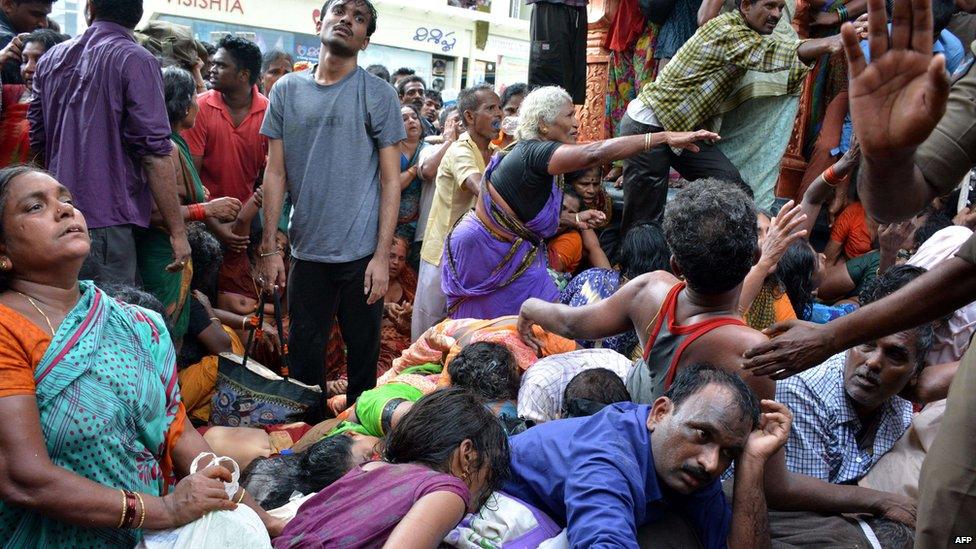 Indian devotees react after a stampede at a religious festival in Godavari in the Rajahmundry district some 200km north-east of Hyderabad on Tuesday