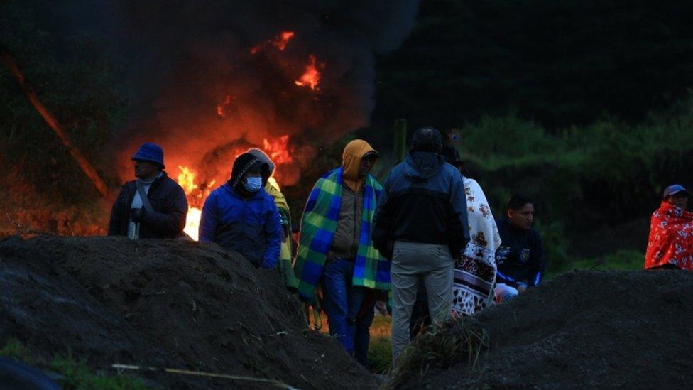 Image shows protestes at road block