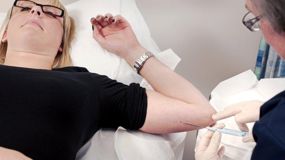 Woman having an implant fitted