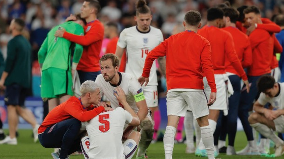 England team comforting each other after defeat at Euros final