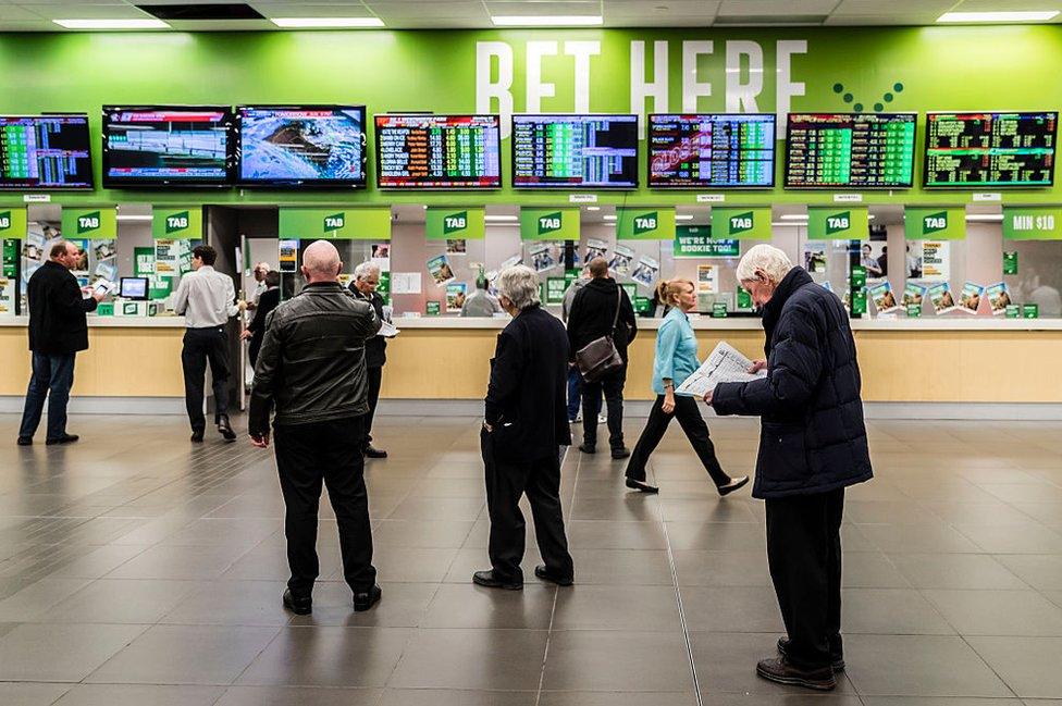 Punters queue to make their bets at the Wentworth Park greyhound racetrack in Sydney