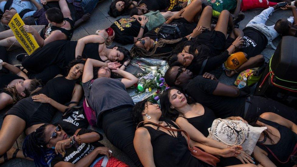 Protesters in Madrid lie on the ground during a performance illustrating the death of migrants at the Spanish-Moroccan border