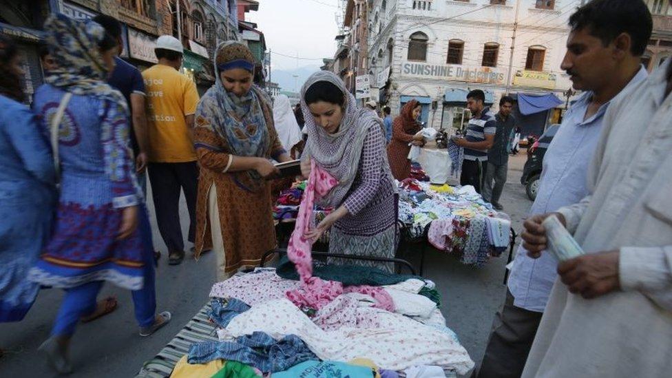 Customers look at the offers at an open market stand in Lal Chowk, the central hub of business activity in Srinagar, the summer capital of Indian Kashmir, 12 September 2016.