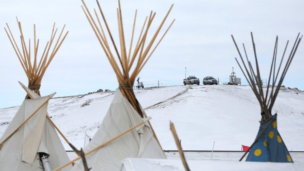 Police vehicles idle on the outskirts of the opposition camp against the Dakota Access oil pipeline near Cannon Ball, North Dakota, U.S., February 8, 2017