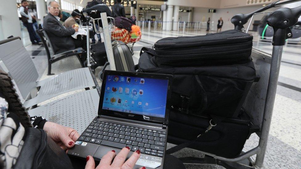 Syrian woman travelling to US through Amman opening her laptop before checking in at Beirut international airport. March 22, 2017