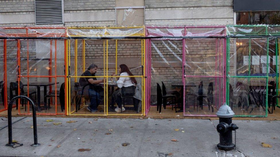 Couple dine outdoors in individual tents in the West Village, New York City, on 26 November 2020