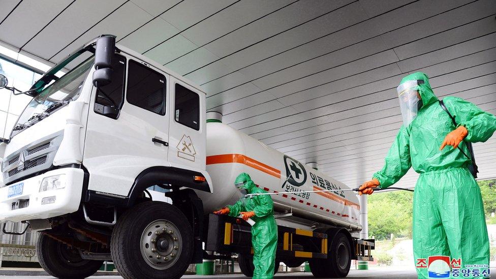 A photo released by the official North Korean Central News Agency (KCNA) on 19 May 2022 shows staff disinfecting the premises of a medical oxygen factory to curb the current coronavirus disease health crisis in Pyongyang, North Korea