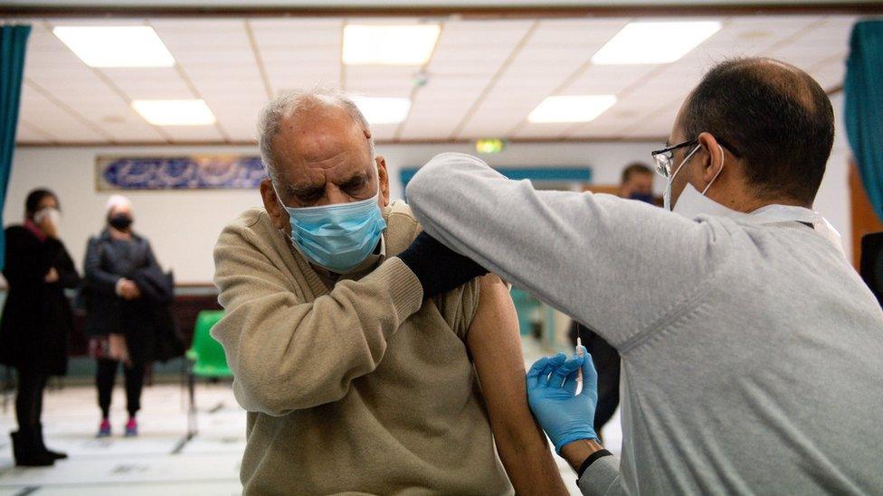 Masud Ahmad, 79, receives an injection of the Oxford/AstraZeneca coronavirus vaccine at the Al Abbas Mosque, Birmingham