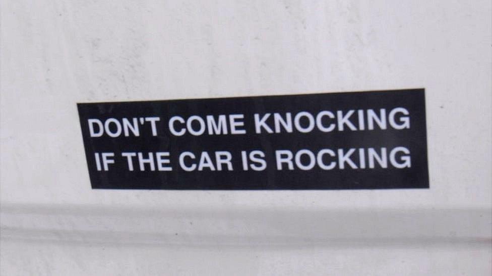 Sticker saying "don't come knocking if the car is rocking"