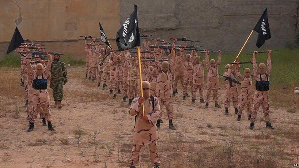 Young recruits to Islamic State wave black banners