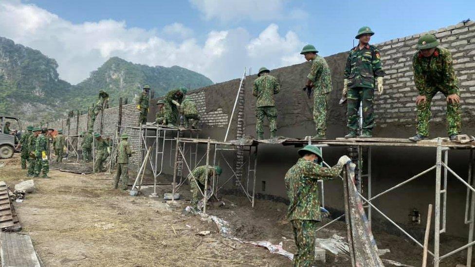 Workers putting up a wall around the airport at Dong Tam, Vietnam - pictures from Facebook