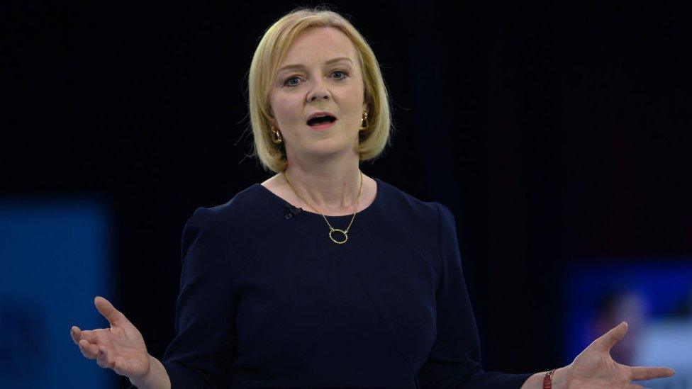 Liz Truss talks to a crowd at a hustings