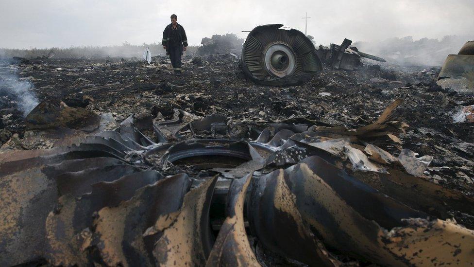 An Emergencies Ministry member walks at a site of a Malaysia Airlines Boeing 777 plane crash near the settlement of Grabovo in the Donetsk region