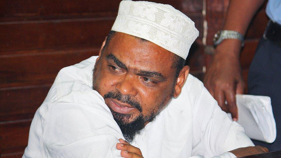 Muslim cleric Aboud Rogo Mohammed sits in the Mombasa Law courts on January 30, 2012 after being charged with possession of dangerous weapons, an AK 47 rifle, 133 rounds of ammunitions, two hand grenades, and two pistols.