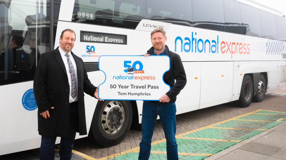 Chris Hardy, managing director UK Coach (left) presenting Tom Humphries with his ticket