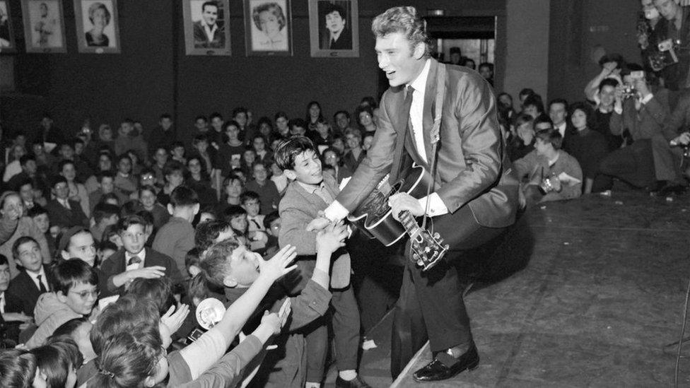 In this file photo taken on December 13, 1962 French singer Johnny Hallyday performs a concert at the Olympia hall in Paris.