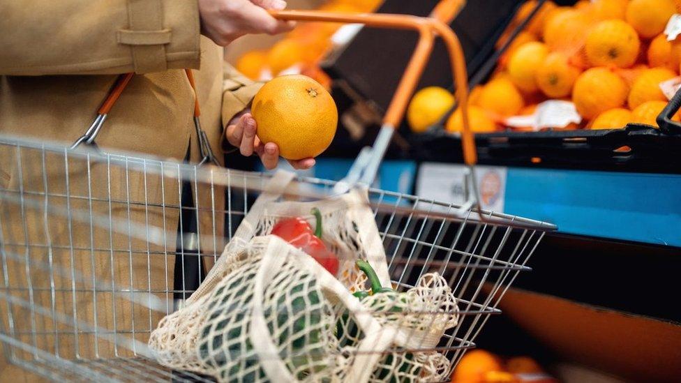 Close up hand with shopping basket