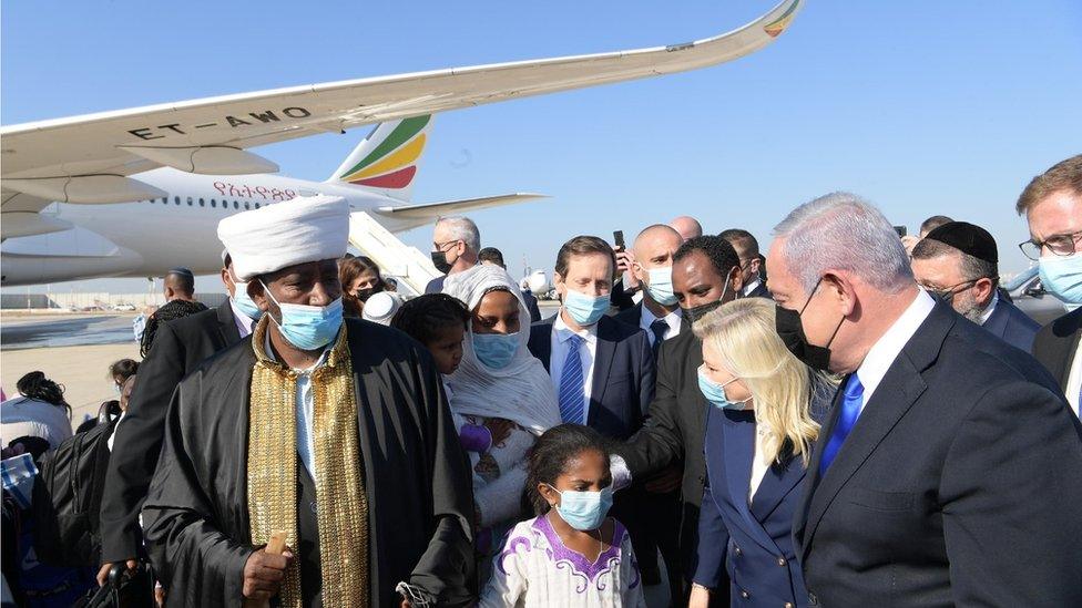 Israeli Prime Minister Benjamin Netanyahu (right) and his wife Sara greet Falash Mura Jews on their arrival at Ben Gurion Airport (03/12/20)