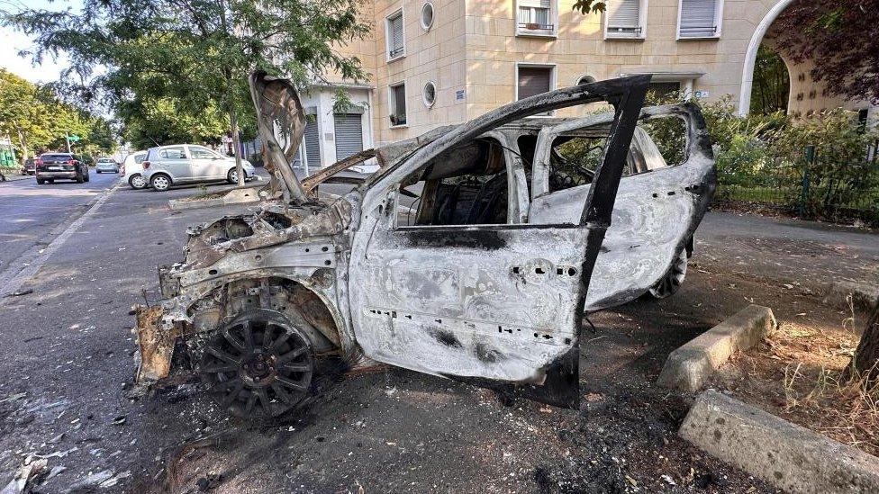 A burnt-out car pictured after riots erupted in Nanterre, Paris following the shooting of a teenager by police