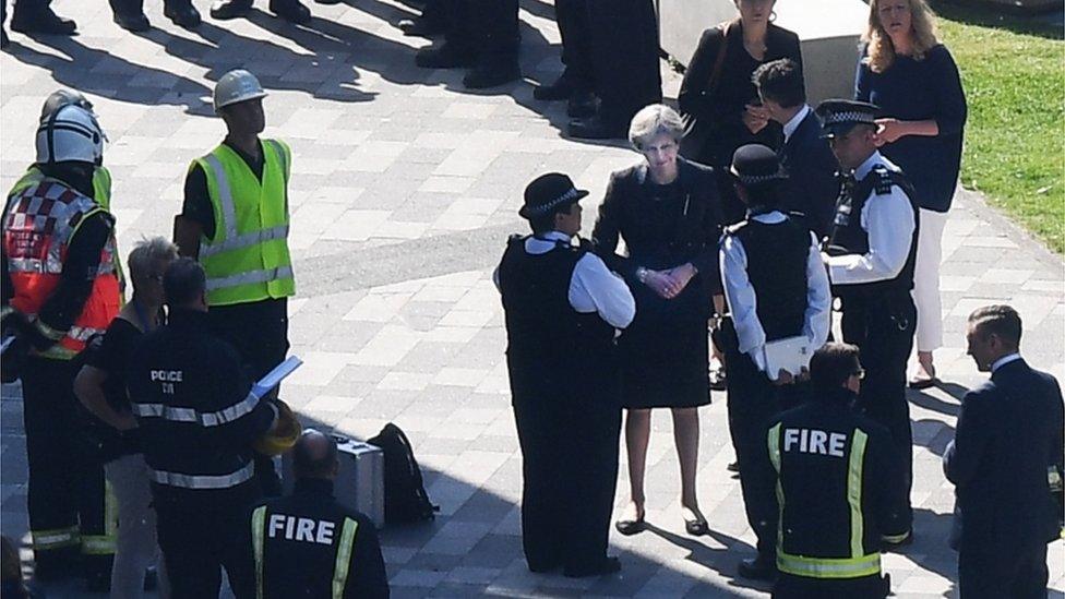 Theresa May meets fire fighters at the Grenfell Tower site