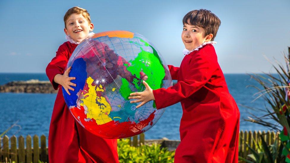 Truro Cathedral Chorister soloists Thomas, 8 and Joseph, 8 play with globe