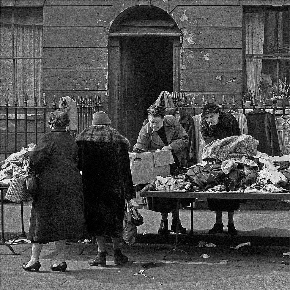 Market ladies sort the clothes in London's East End