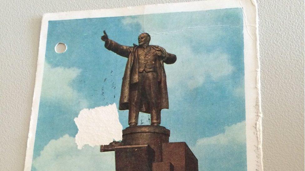 A postcard showing a statue of Lenin